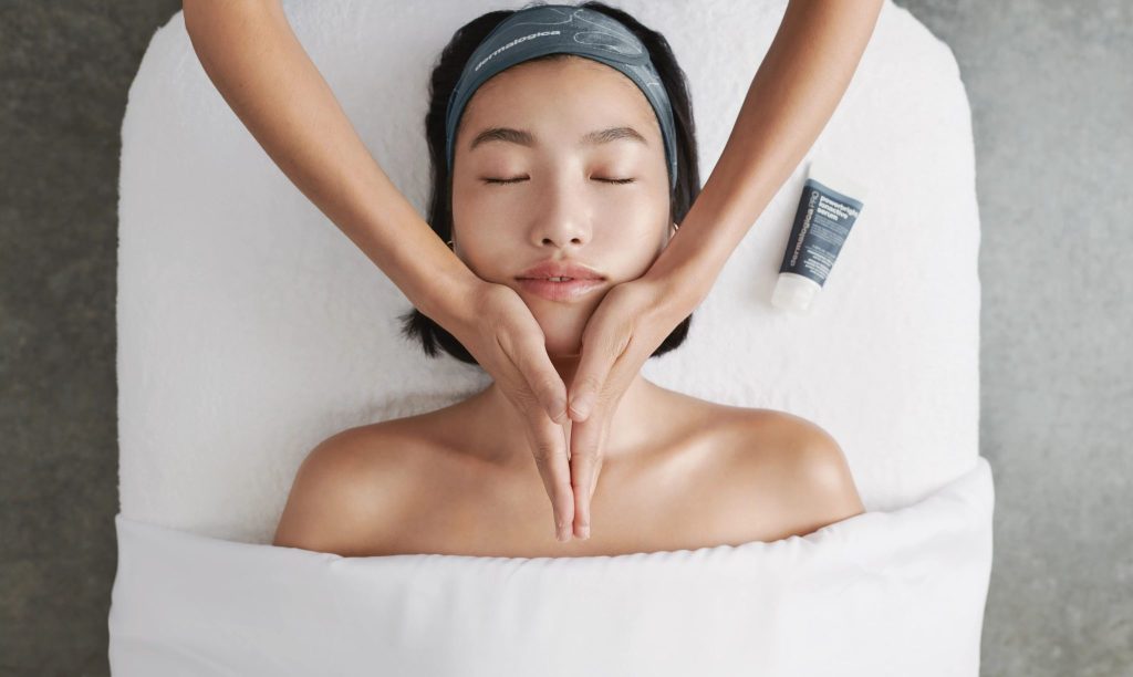 Chiropractic facial massage: Woman receiving gentle facial manipulation as part of a chiropractic treatment for TMJ or tension headaches.
